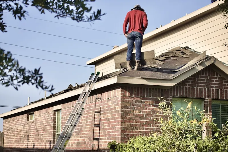 Professional roofer working on a residential roof in South Maywood